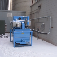 A Powerlift located outside a grain silo. The system is moved around the facility to multiple tubing runs. 